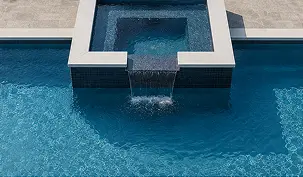 A square hot tub overflows into a larger rectangular swimming pool.