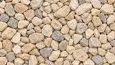 A collection of light-colored, varied-sized stones packed closely together.