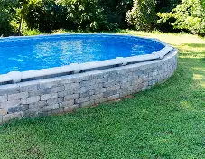 Above-ground pool in a landscaped backyard