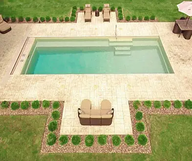 An aerial view of a rectangular swimming pool surrounded by a stone patio, outdoor seating, and manicured landscaping.