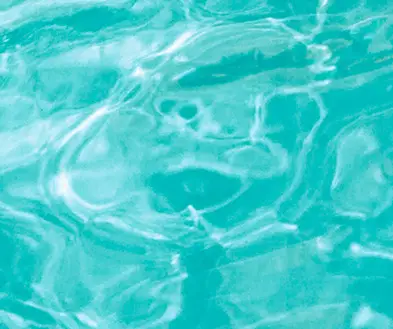 Rippling turquoise water with light reflecting on the surface.