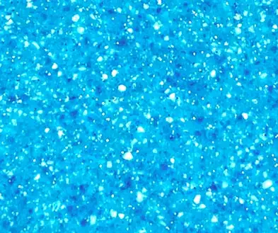 A bright blue surface with a speckled, multi-toned texture.