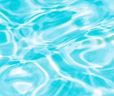 Close-up of bright blue water with rippling sunlight reflections.