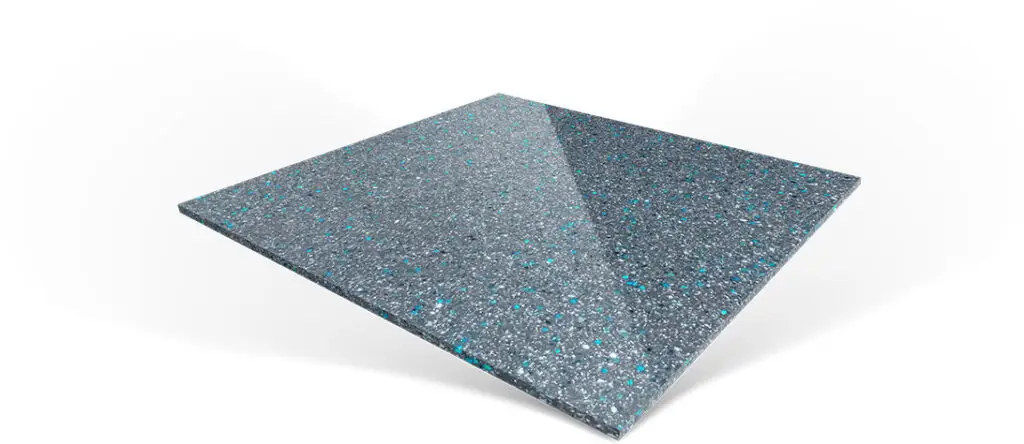 A square slab of grey speckled composite material with flecks of blue and white.