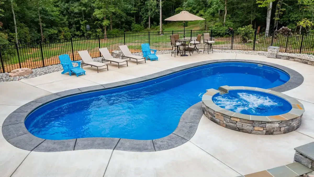The Inspiration freeform pool with an inviting splash pad